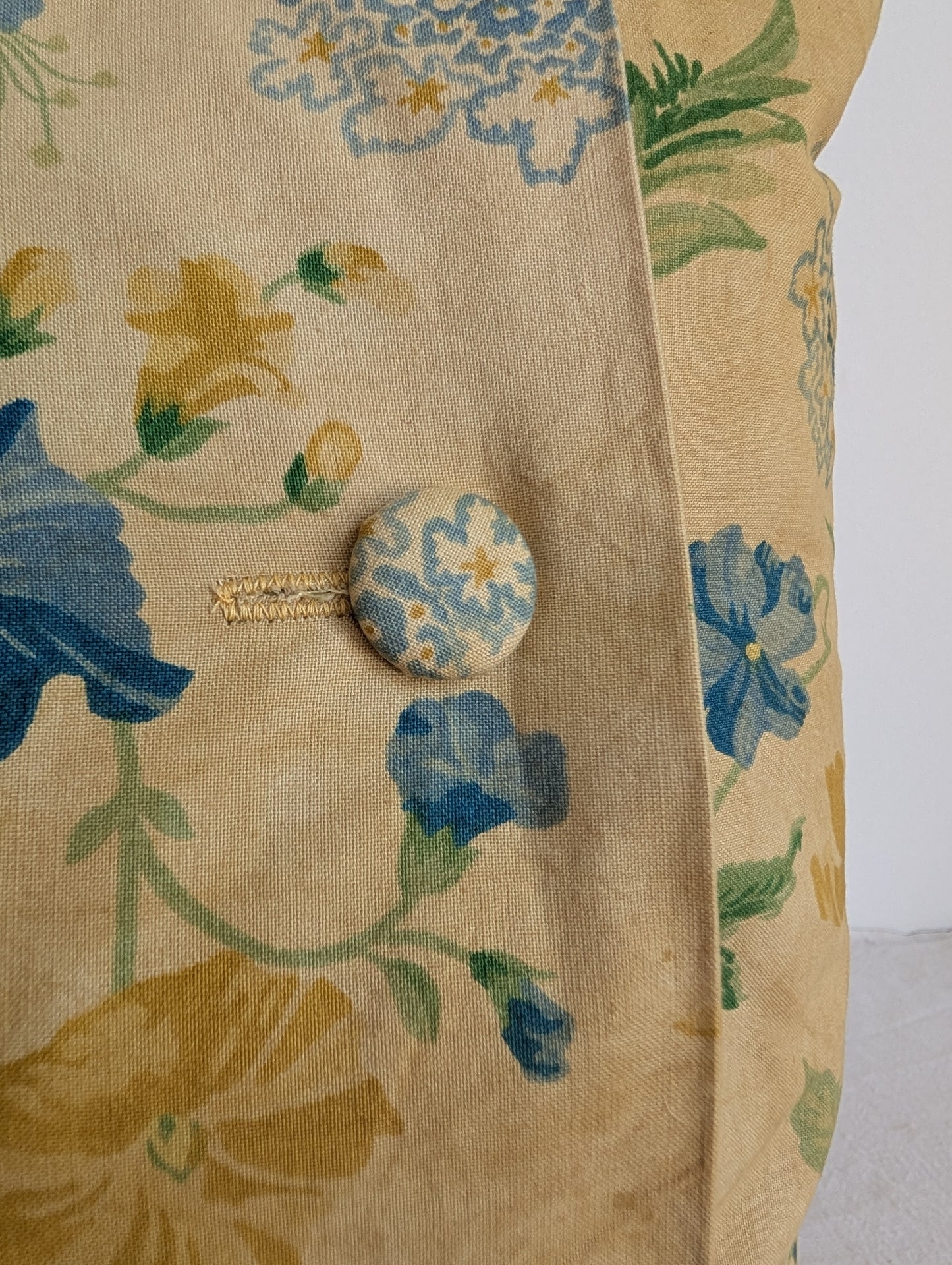Light yellow floral cushion dyed with pomegranate