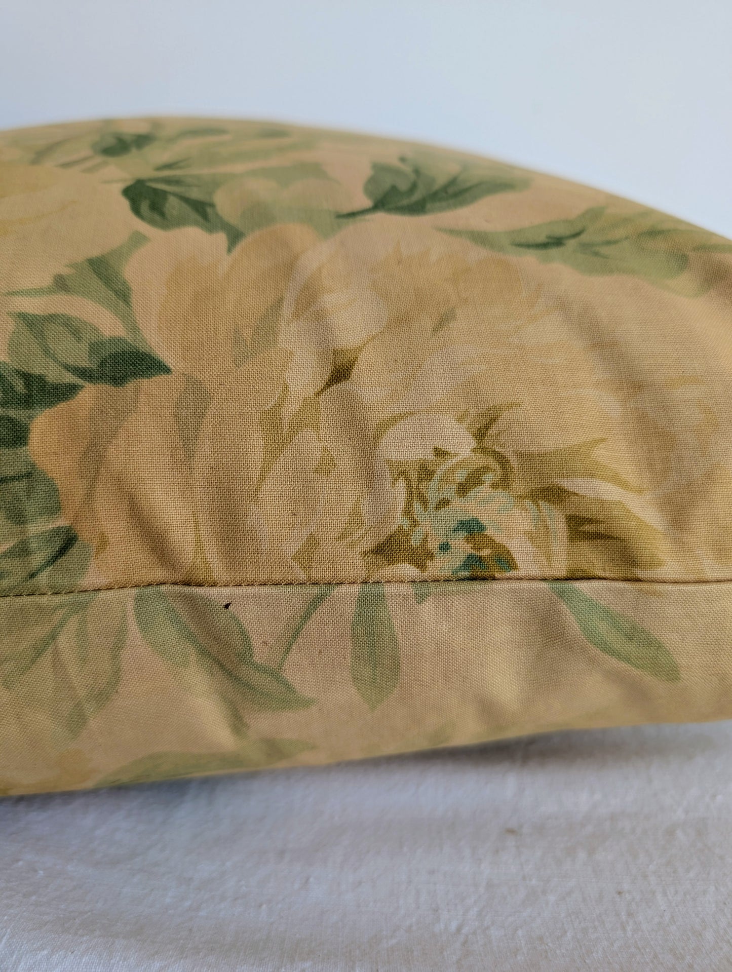 Light yellow floral cushion dyed with rhubarb root